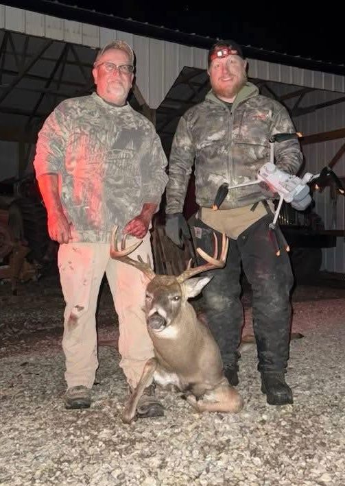 two men with a recovered deer